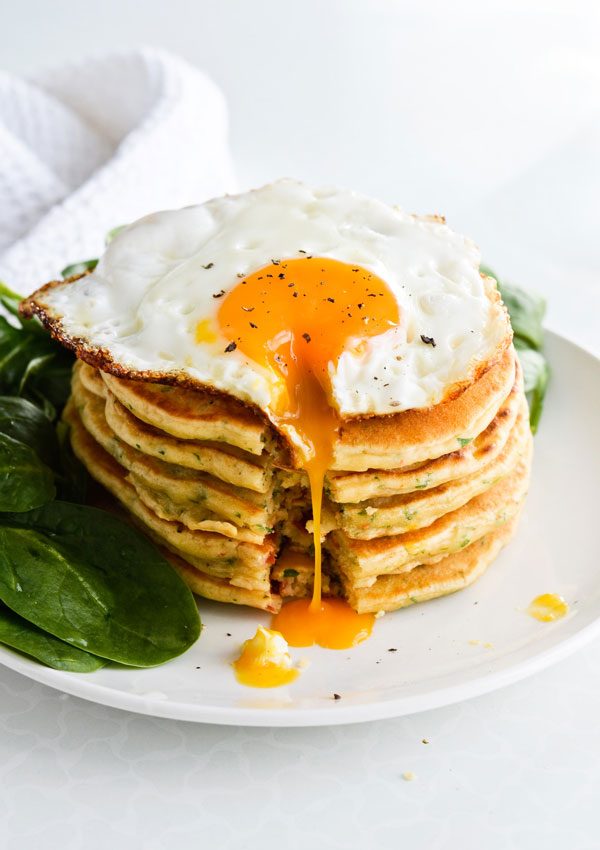 savory pancakes with fried egg and spinach