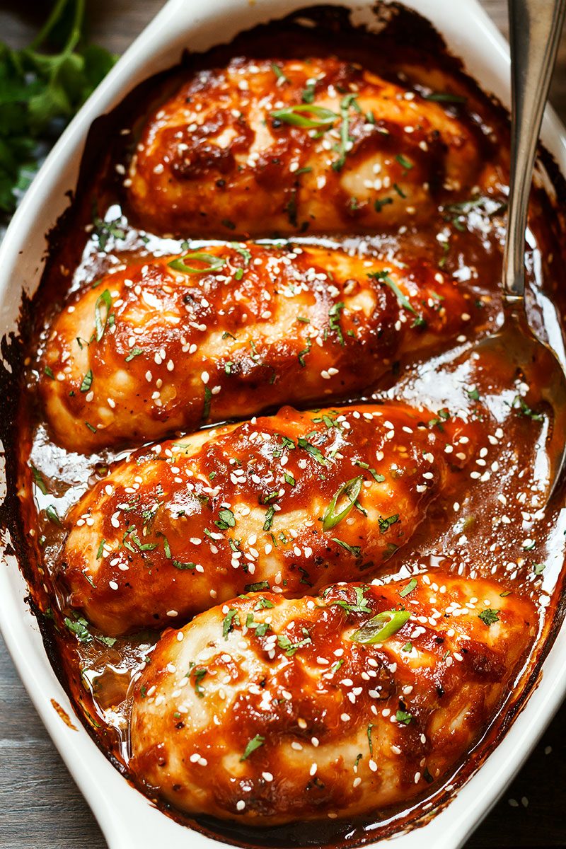 Baked Chicken Breasts with Sticky Honey Sriracha Sauce — Bursting with flavor and perfectly juicy. Say goodbye to bland, and dry oven baked chicken!