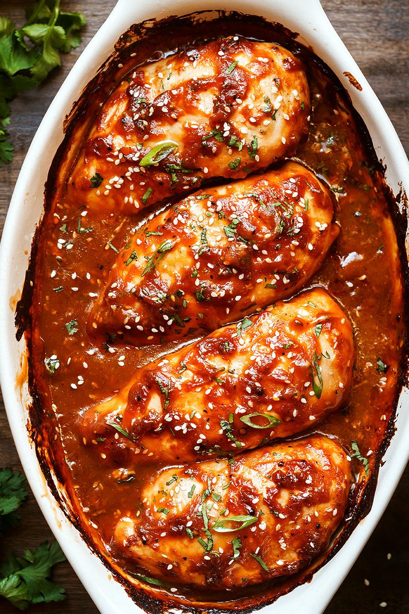 Baked Chicken Breasts with Sticky Honey Sriracha Sauce — Bursting with flavor and perfectly juicy. Say goodbye to bland, and dry oven baked chicken!