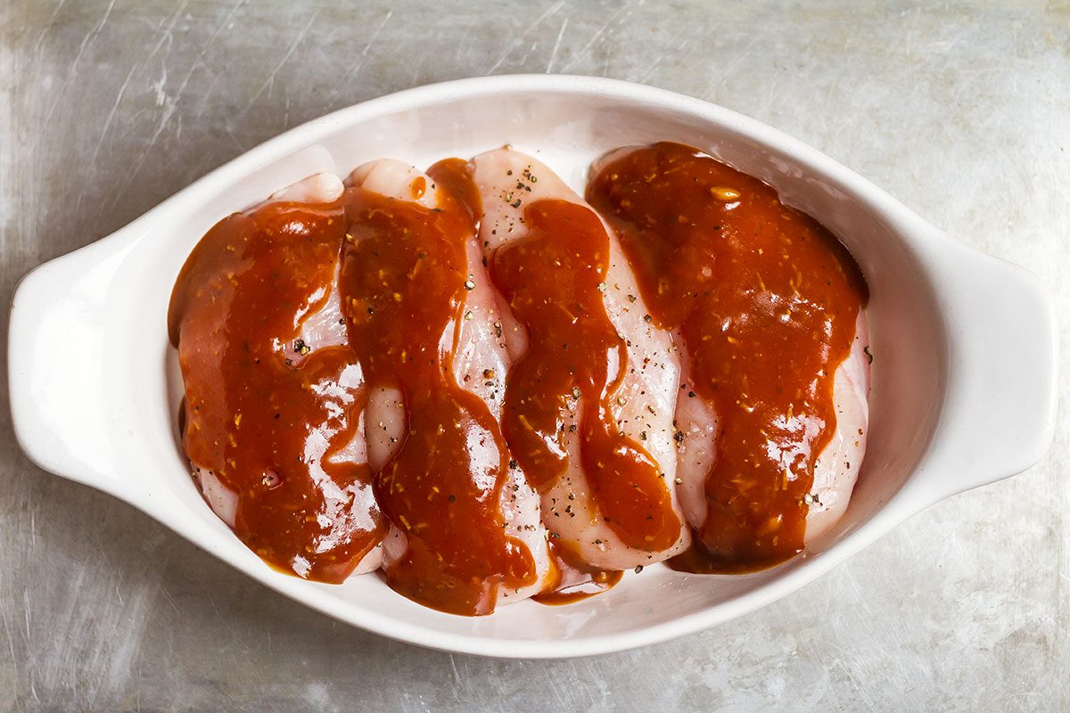Baked Chicken Breasts with Sticky Honey Sriracha Sauce — Bursting with flavor and perfectly juicy. Say goodbye to bland, and dry oven baked chicken!