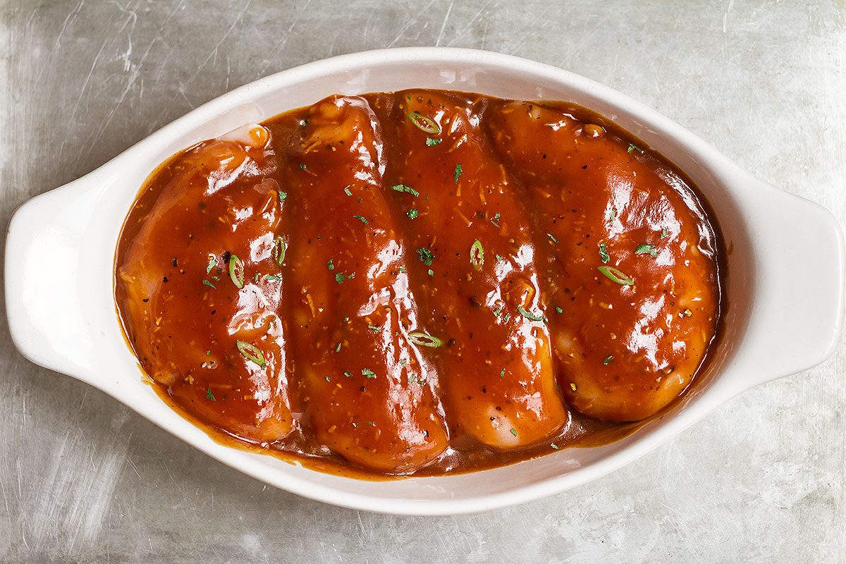 Baked Chicken Breasts with Sticky Honey Sriracha Sauce — Bursting with flavor and perfectly juicy. Say goodbye to bland, and dry oven baked chicken!