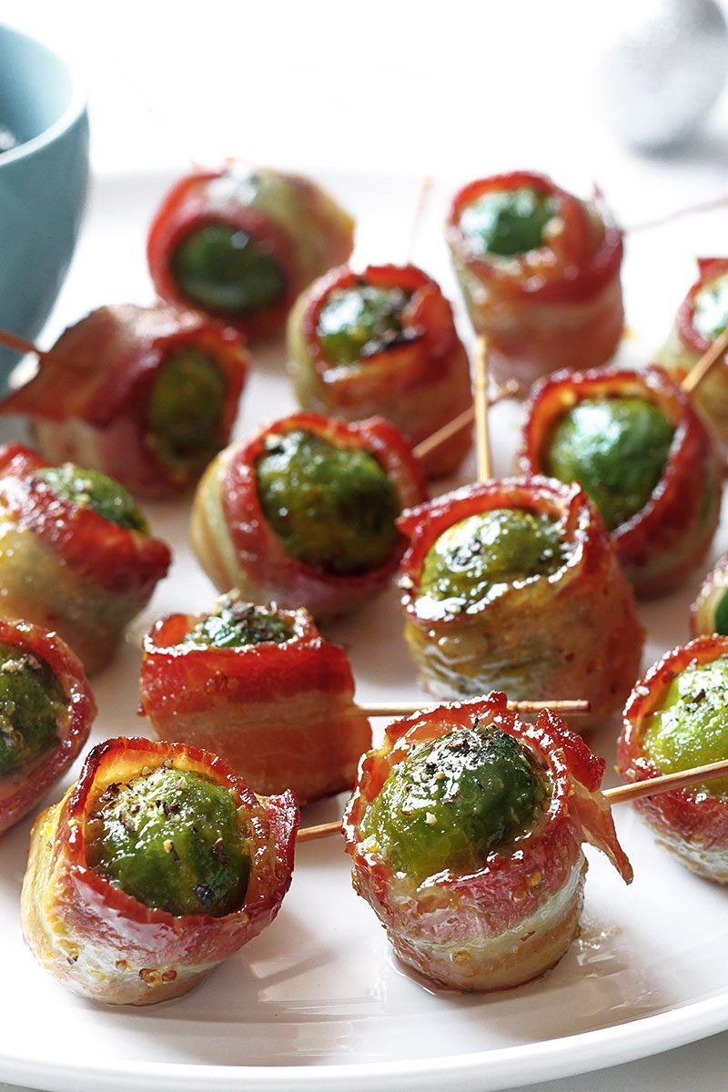 Bacon Maple Roasted Brussels Sprouts — Tender goodness of Brussels sprouts and extra-crispy bacon are a perfect addition to your snack table!