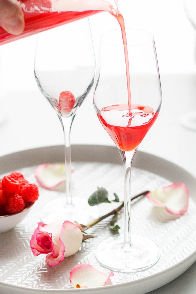 Raspberry Mimosa Cocktail - Let champagne shine! This sparkling raspberry mimosa is the perfect drink to sip on Valentine's Day.
