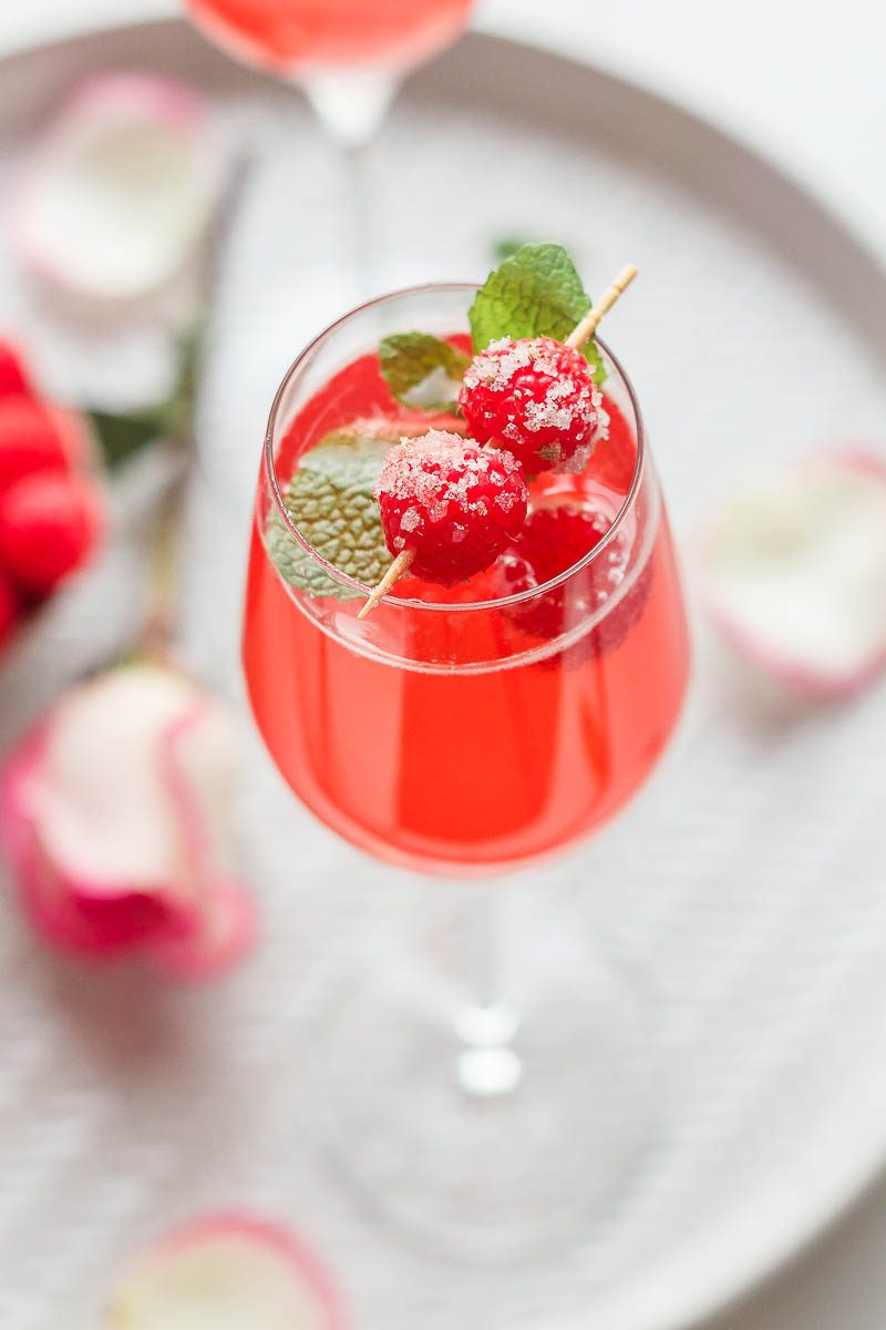 Raspberry Mimosa Cocktail - Let champagne shine! This sparkling raspberry mimosa is the perfect drink to sip on Valentine's Day.