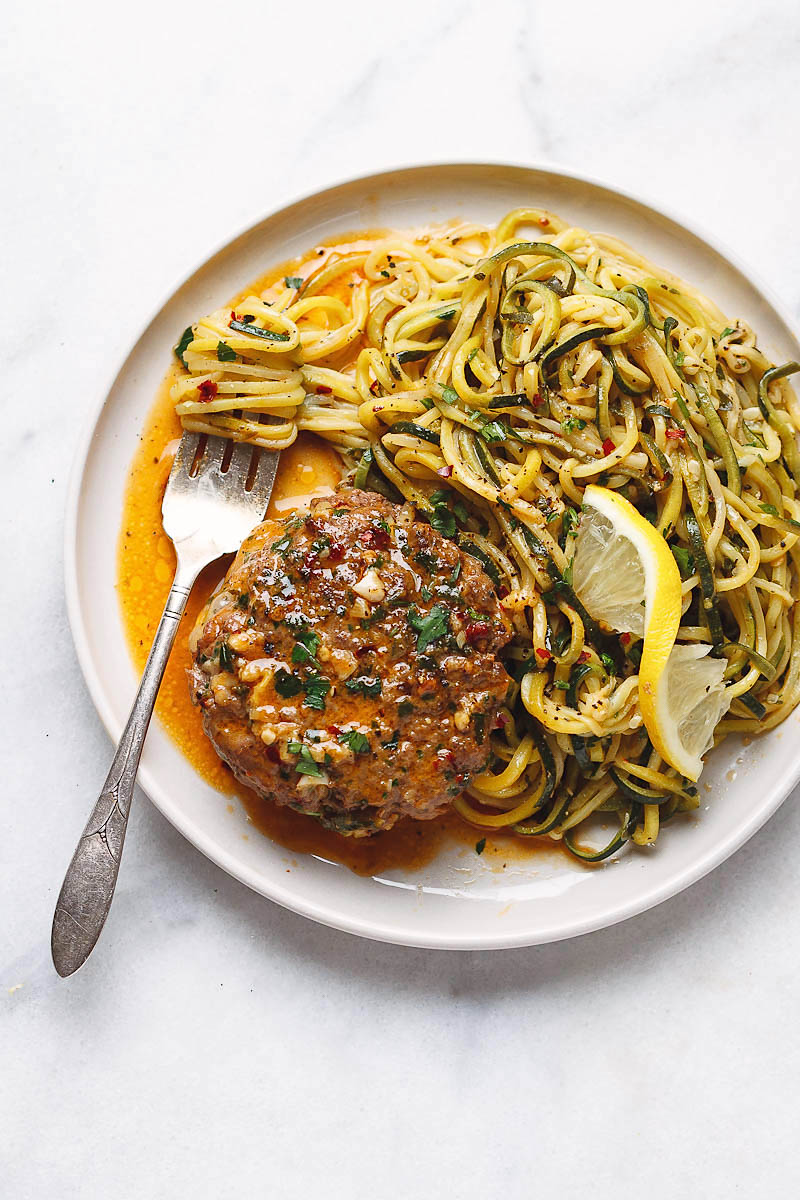 Cheesy Garlic Burgers with Lemon Butter Zucchini Noodles - Rich and juicy, you'll instantly fall in love with these hamburger patties served with plenty of lemony zucchini noodles.