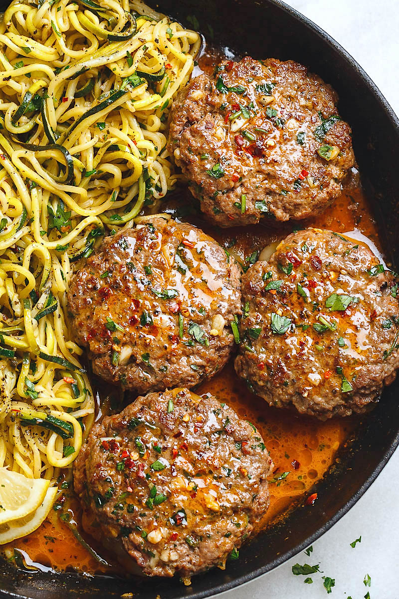 Cheesy Garlic Burgers with Lemon Butter Zucchini Noodles - Rich and juicy, you'll instantly fall in love with these hamburger patties served with plenty of lemony zucchini noodles.