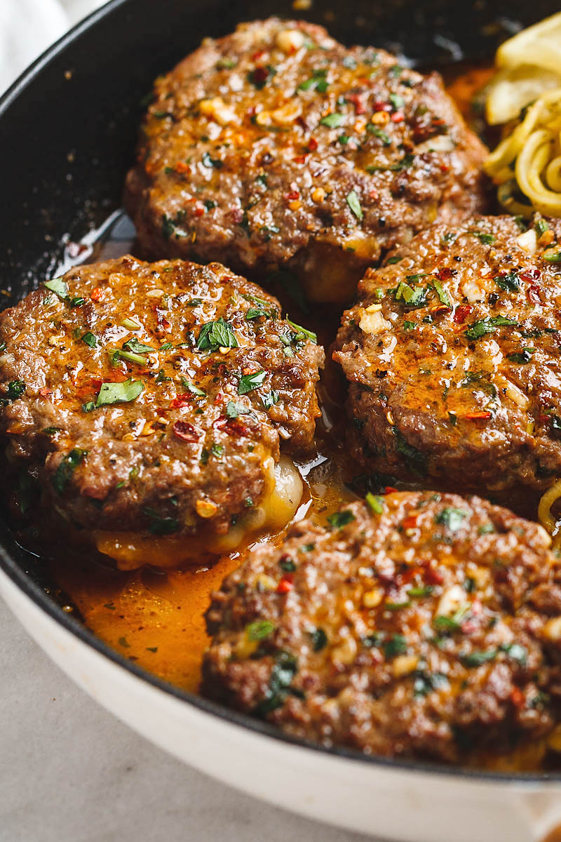 Cheesy Garlic Burgers with Lemon Butter Zucchini Noodles - Rich and juicy, you'll instantly fall in love with these hamburger patties served with plenty of lemony zucchini noodles. - #recipe by #eatwell101