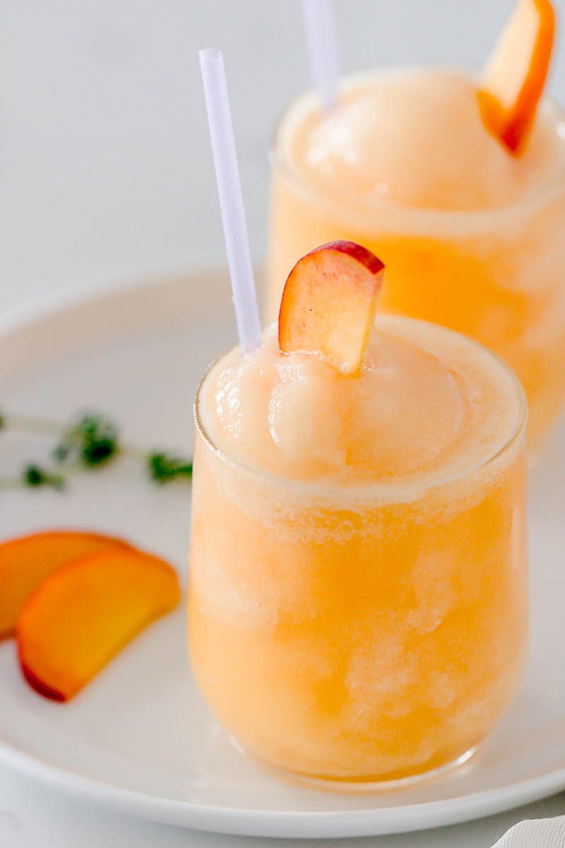 Frozen Peach Bellini Cocktail - Light, refreshing and super easy to make! This elegant cocktail slush will be a hit for any summer party.