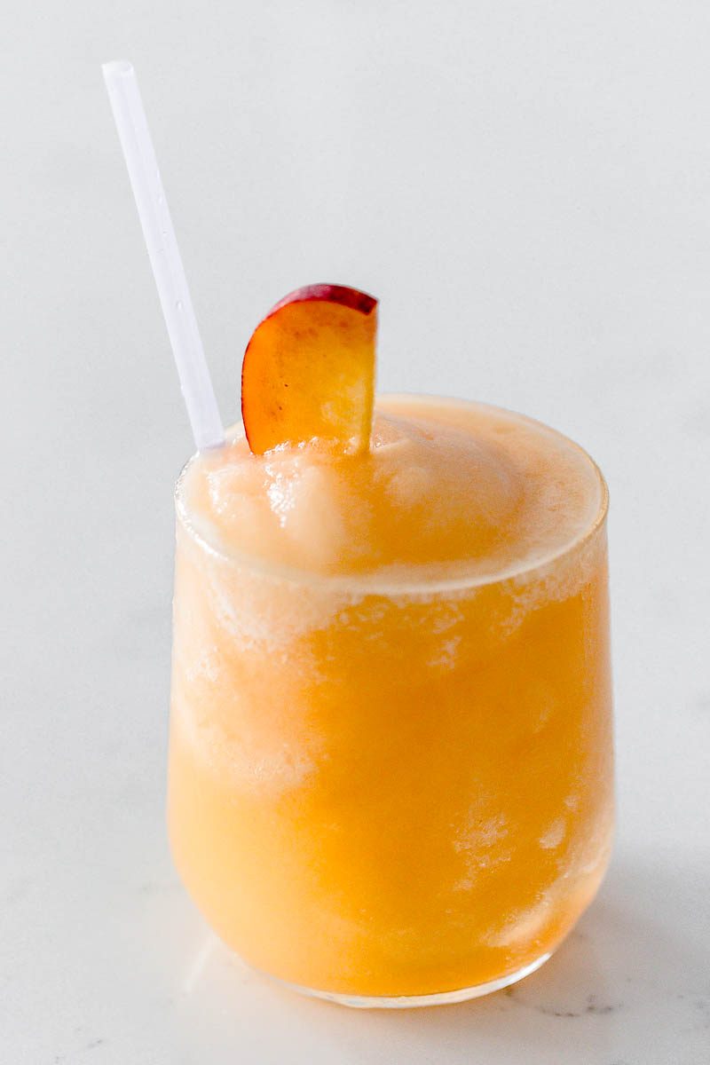 Frozen Peach Bellini Cocktail - Light, refreshing and super easy to make! This elegant cocktail slush will be a hit for any summer party.