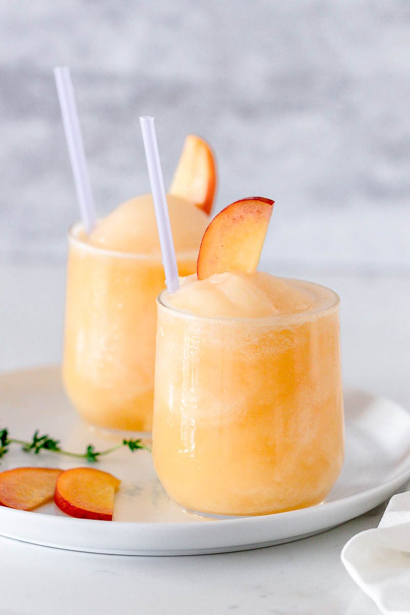 Frozen Peach Bellini Cocktail - Light, refreshing and super easy to make! This elegant cocktail slush will be a hit for any summer party.