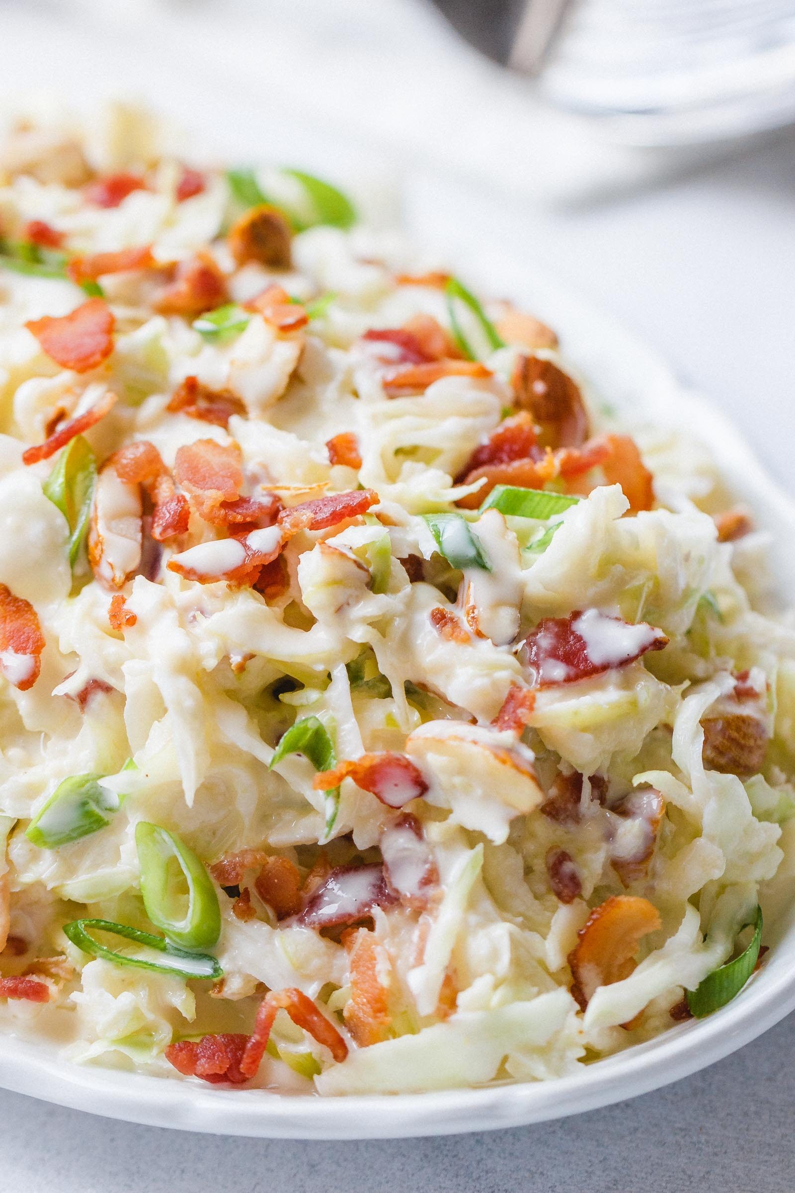 Apple Bacon Coleslaw - Super creamy, crunchy, and fresh! This coleslaw recipe only takes a few minutes to make and is packed with bright and delicious flavor!