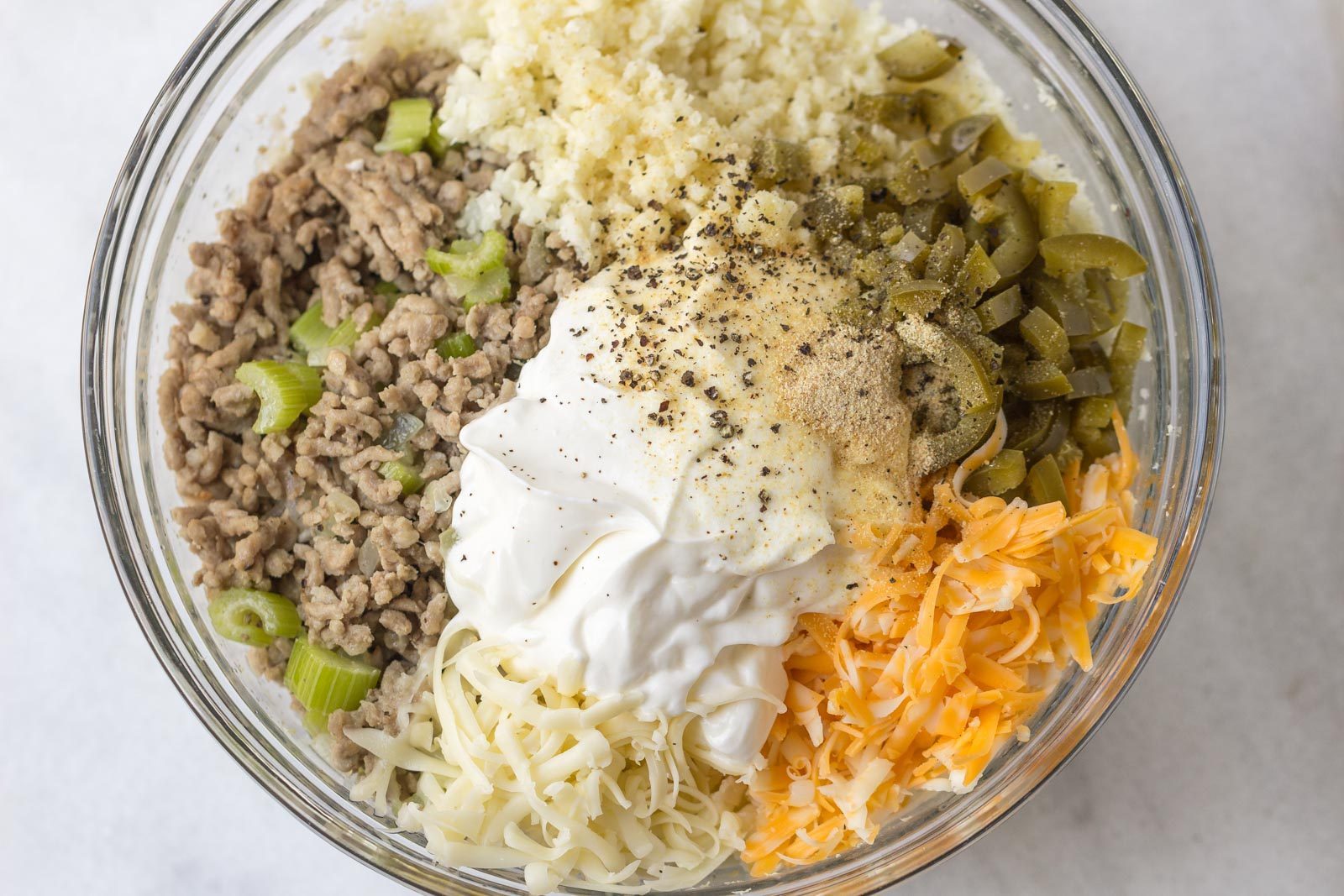 Green Chile Cauliflower Casserole - Warm and addicting comfort food alert! A quick, easy and great for your weekly meal rotation!