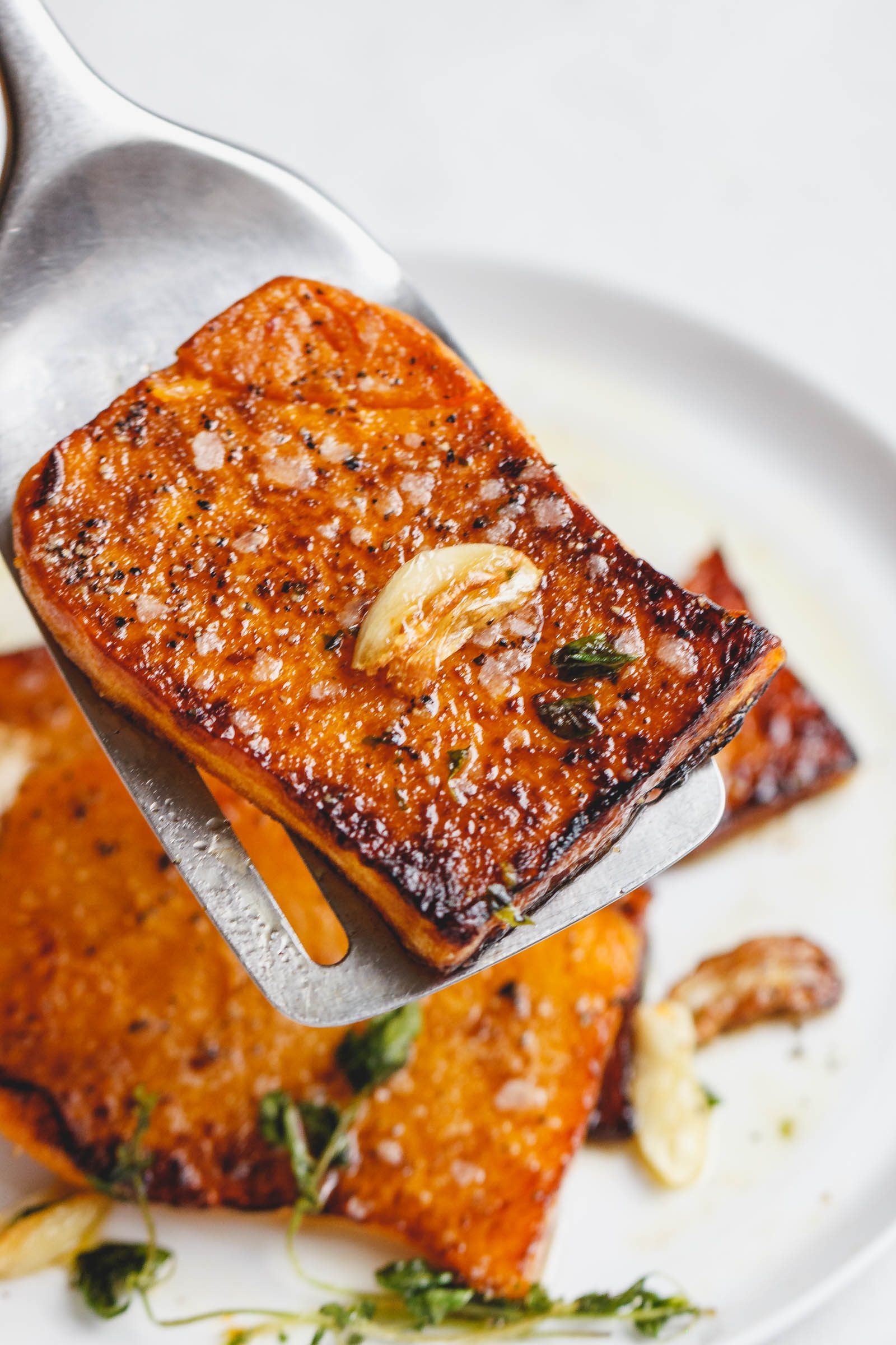 Garlic Butter Butternut Squash Steaks - Melt-in-your-mouth tender and packed with flavor! A super easy and delicious side dish for the holidays.