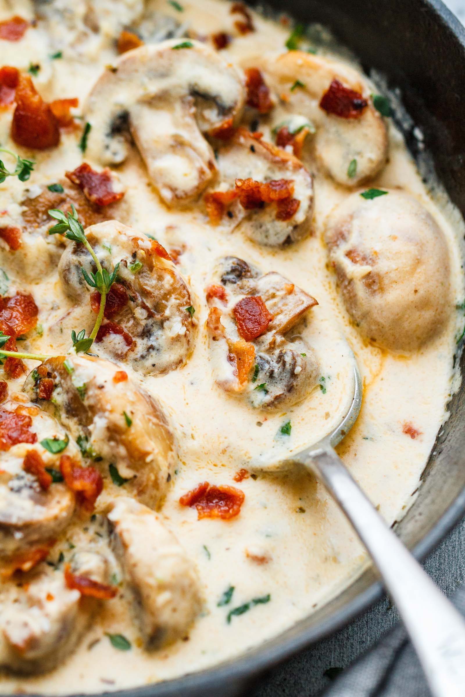Creamy Garlic Parmesan Mushrooms with Bacon - A decadent garlic parmesan mushroom cream sauce that will have you licking your plate clean!