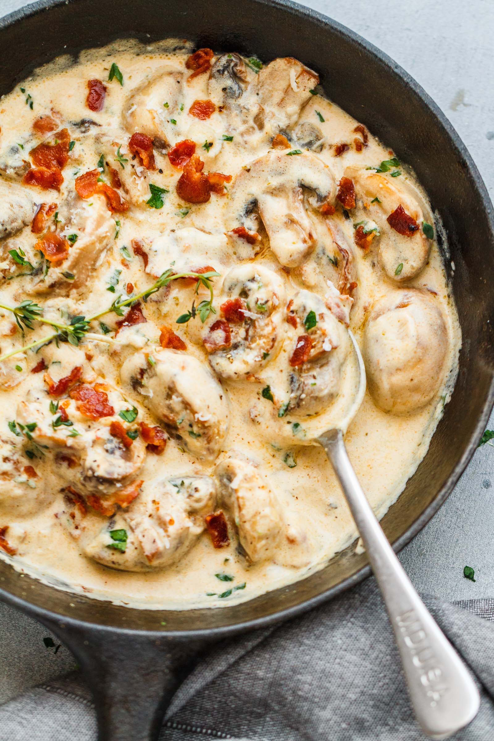 Creamy Garlic Parmesan Mushrooms with Bacon - A decadent garlic parmesan mushroom cream sauce that will have you licking your plate clean!