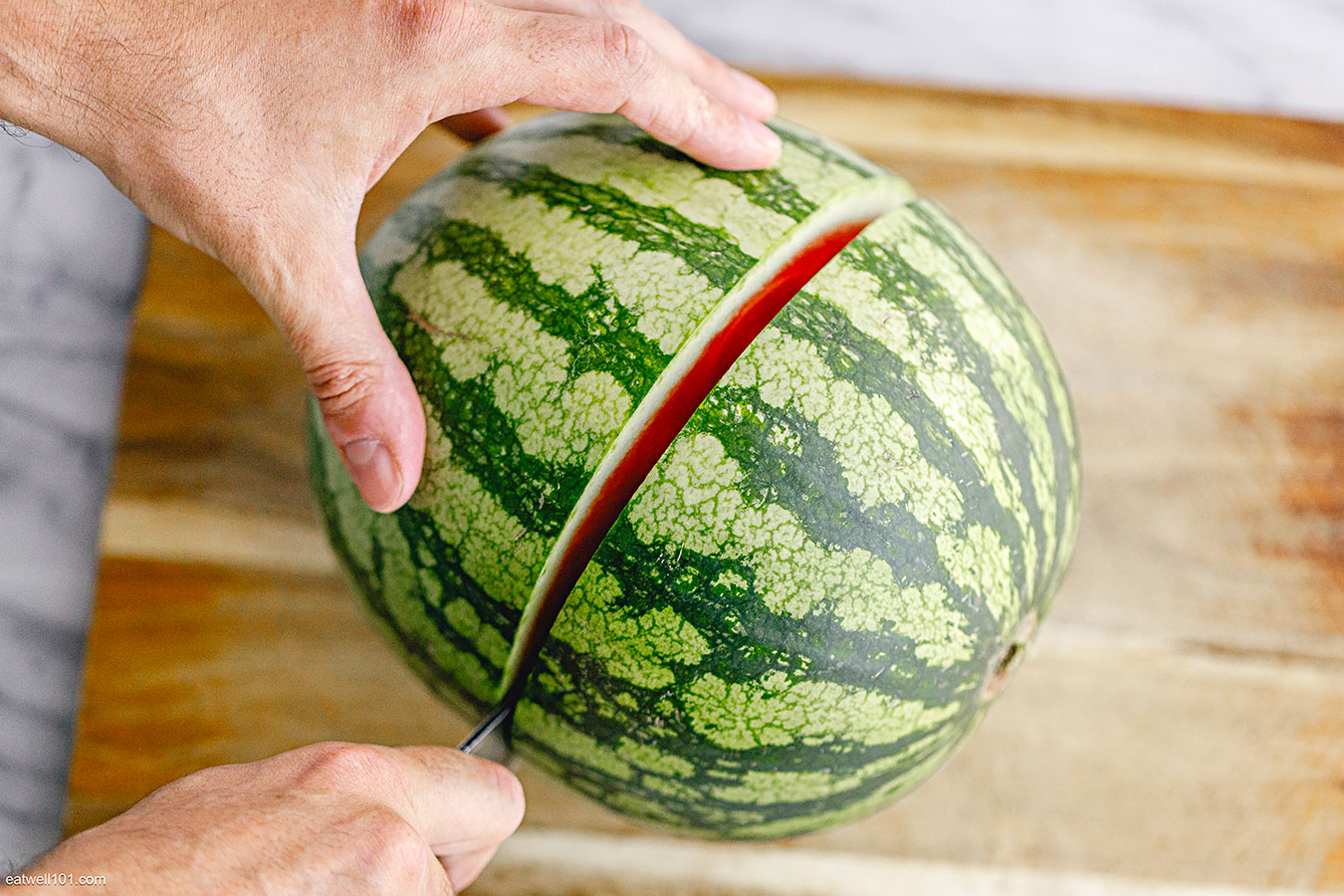 cutting a watermelon in half
