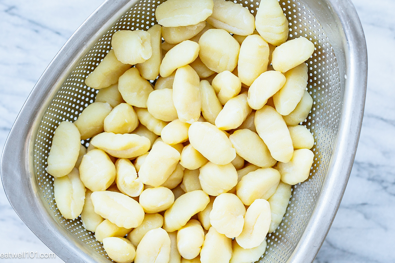 fresh cooked gnocchi in a colander