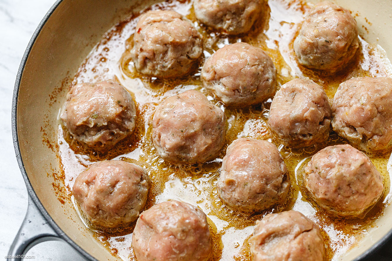 raw turkey meatballs in a skillet