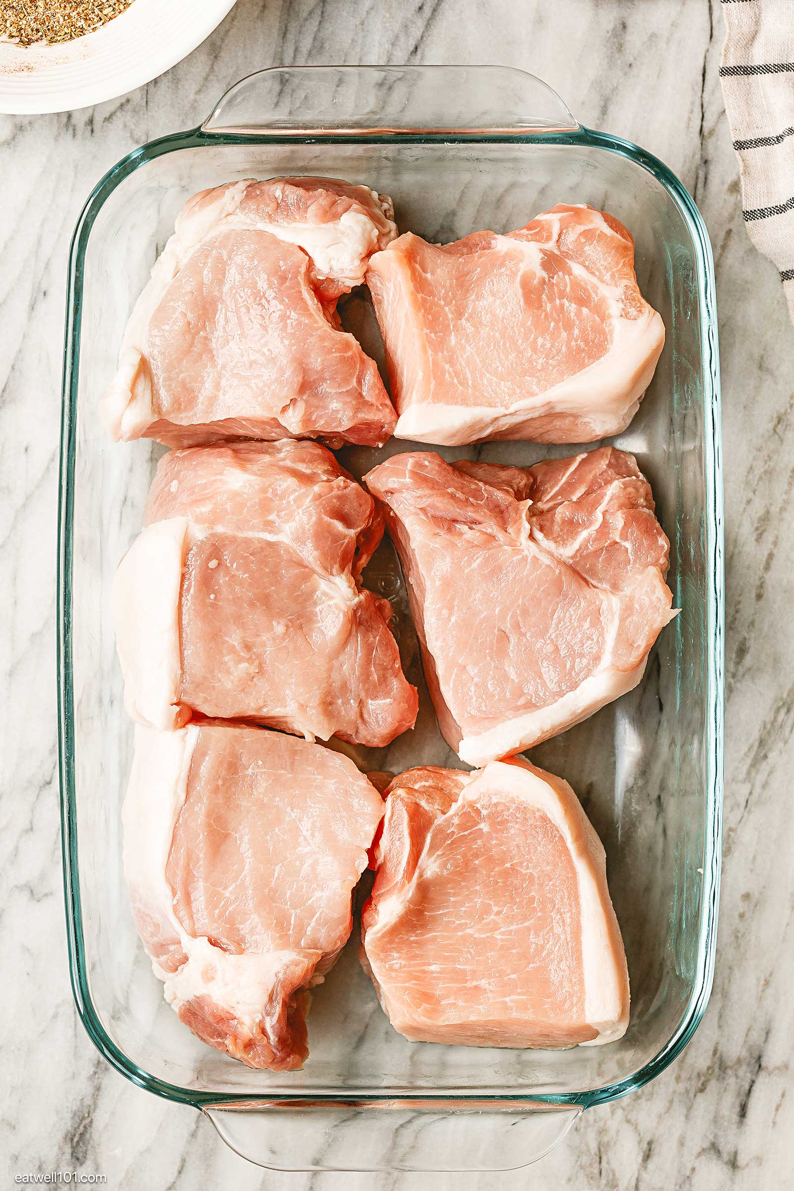 raw pork chops in baking dish