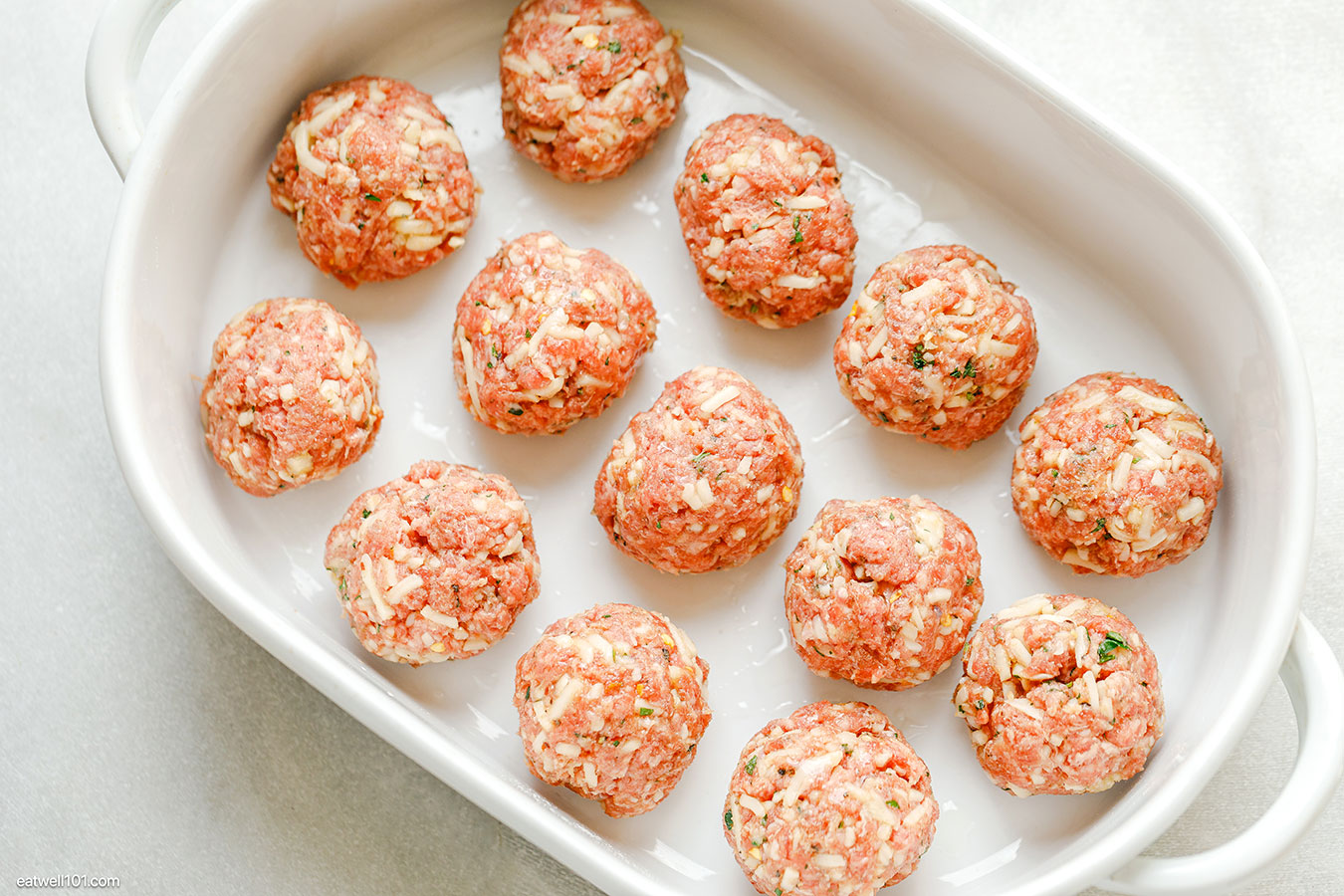 raw meatballs in a baking dish