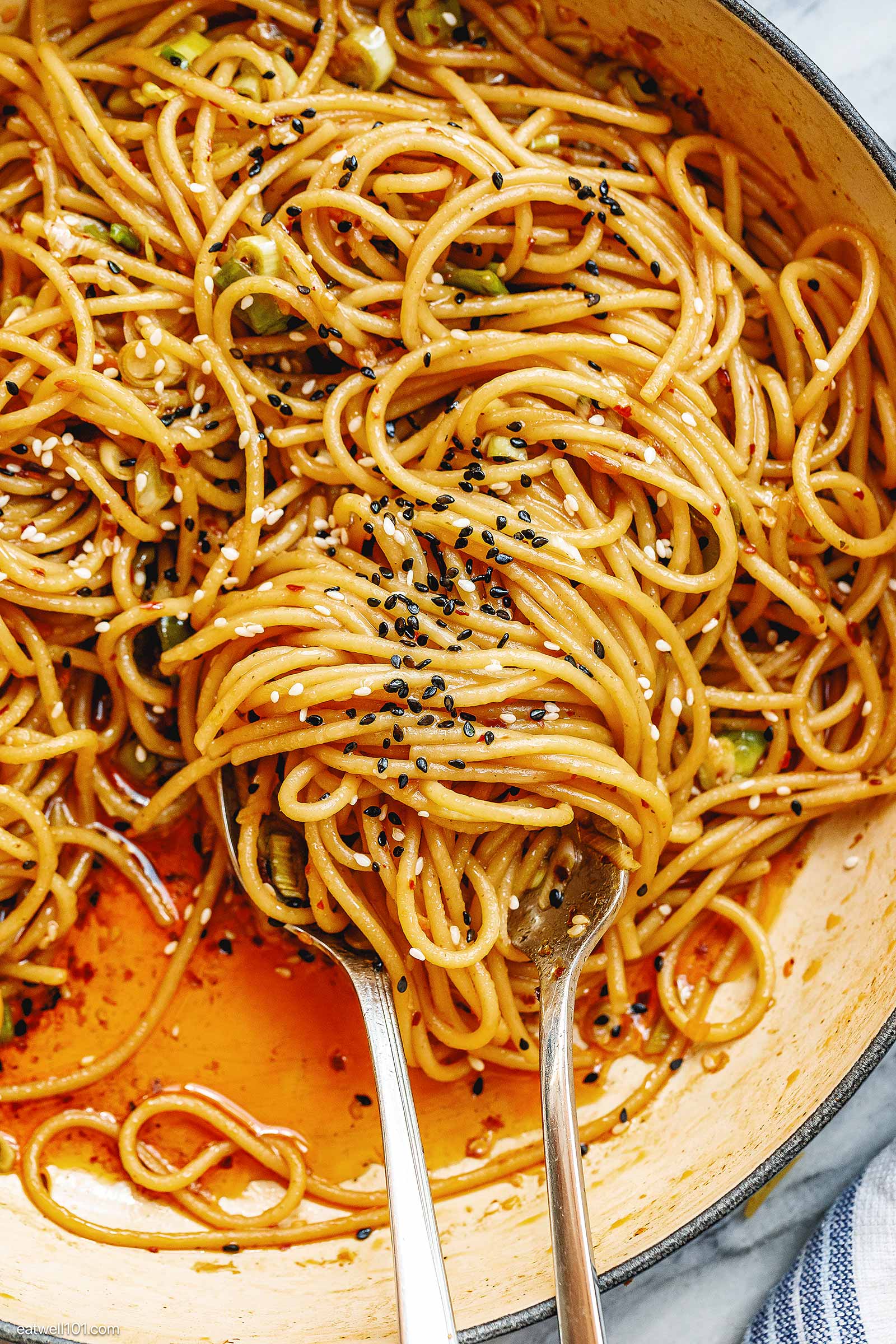 tossing noodles in the pan